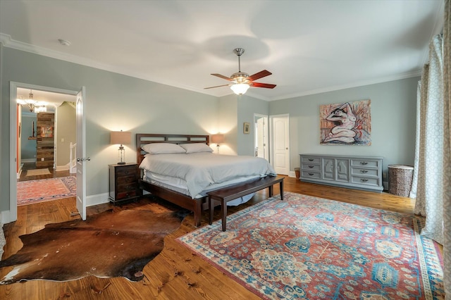 bedroom with wood-type flooring, ceiling fan with notable chandelier, and ornamental molding