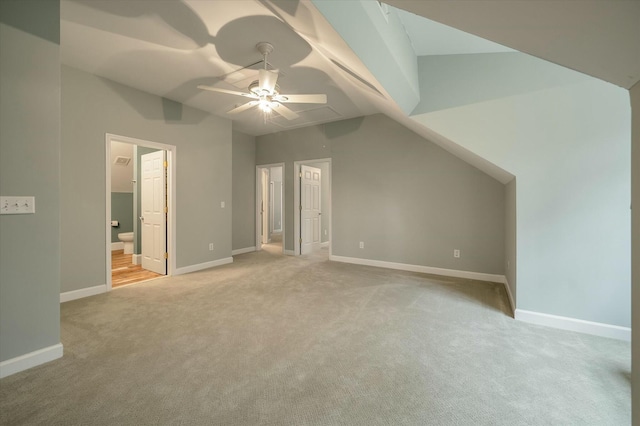 bonus room with ceiling fan, vaulted ceiling, and light carpet