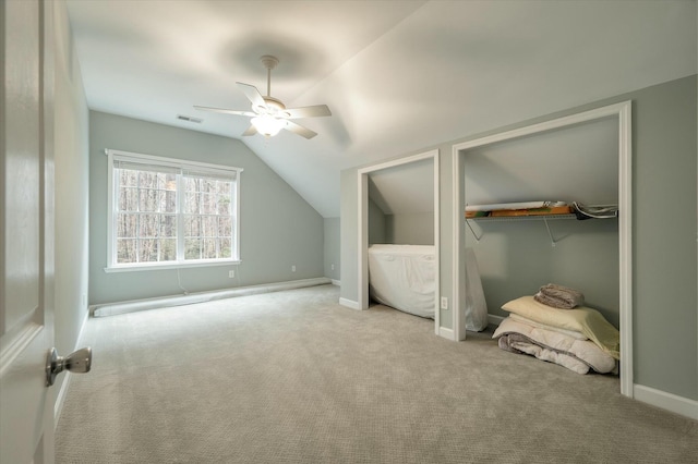 bonus room with light carpet, ceiling fan, and vaulted ceiling