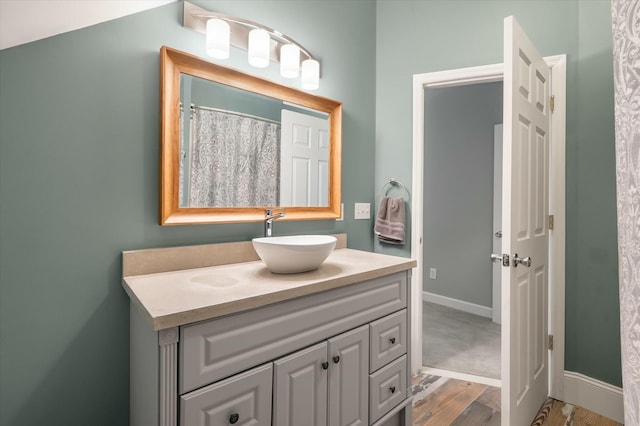 bathroom with hardwood / wood-style floors and vanity