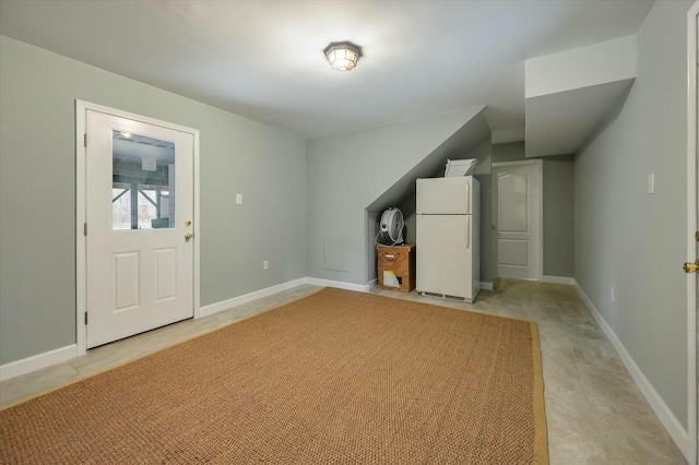 interior space featuring light tile patterned floors and white refrigerator