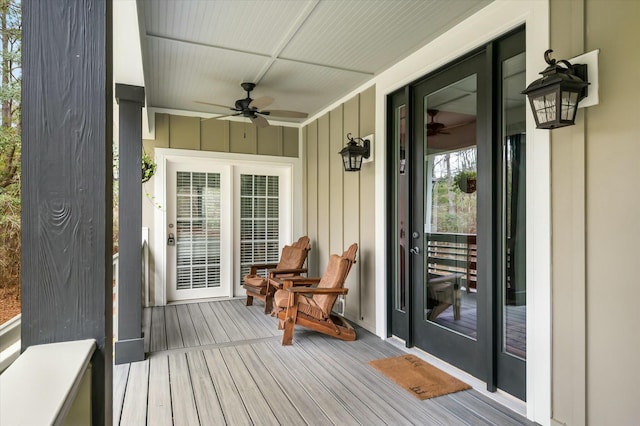 wooden deck featuring ceiling fan and covered porch