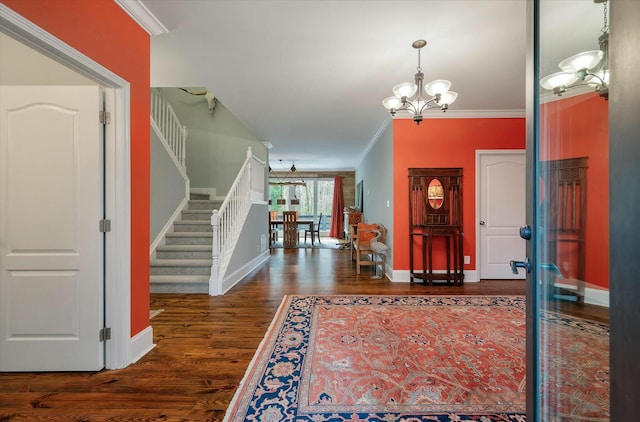 entryway with dark hardwood / wood-style flooring, crown molding, and a notable chandelier