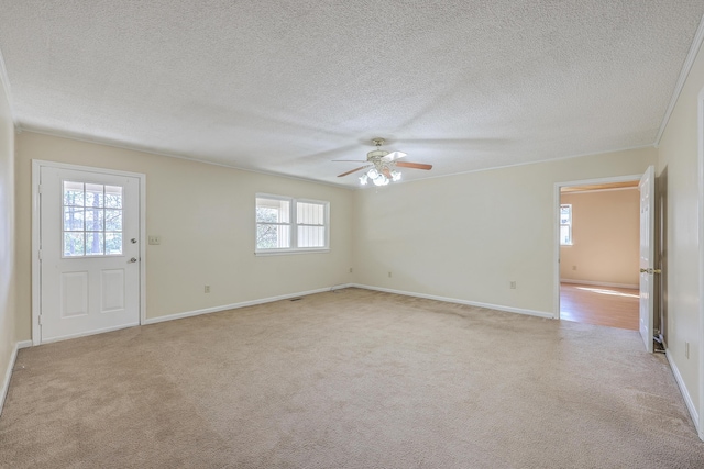 interior space with baseboards, carpet flooring, a textured ceiling, and a ceiling fan