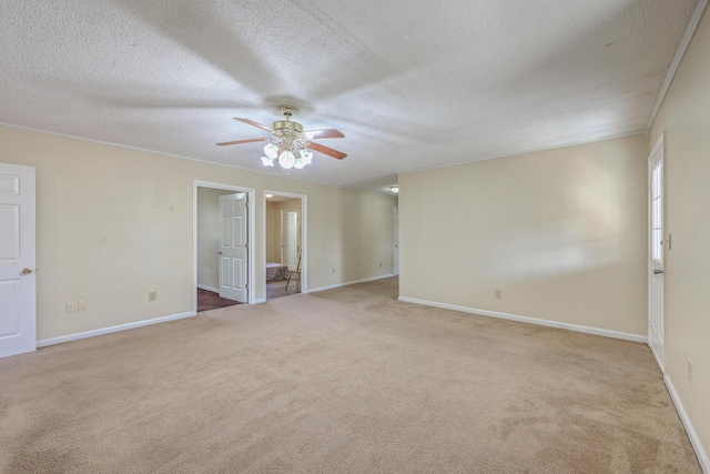 carpeted spare room with baseboards, a textured ceiling, and a ceiling fan