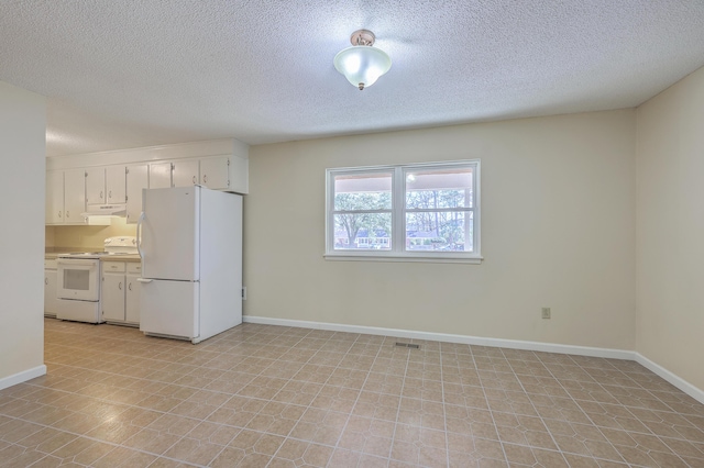 kitchen with baseboards, white appliances, white cabinets, and light countertops