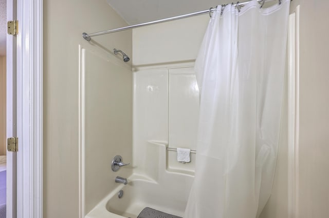 bathroom with shower / bath combination with curtain