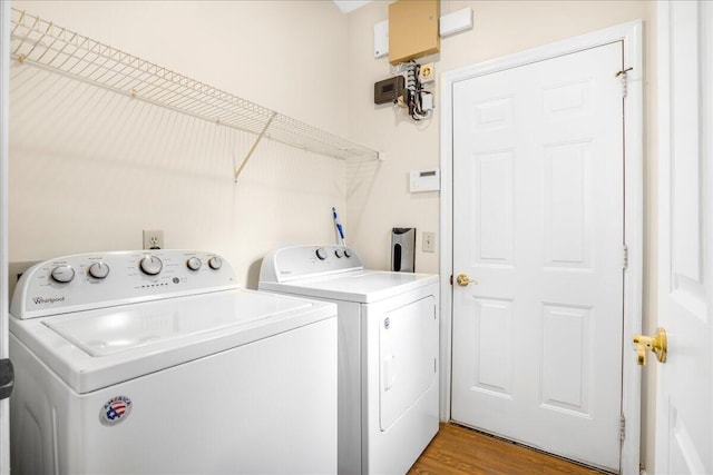 laundry area featuring light hardwood / wood-style flooring and washer and dryer