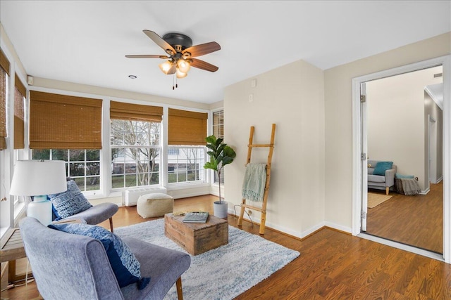 living room featuring hardwood / wood-style floors and ceiling fan