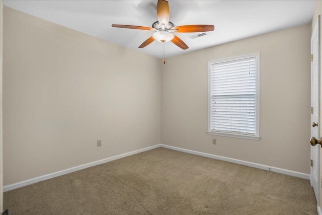 carpeted spare room with ceiling fan