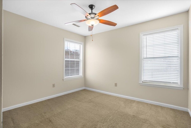 spare room with carpet flooring and ceiling fan