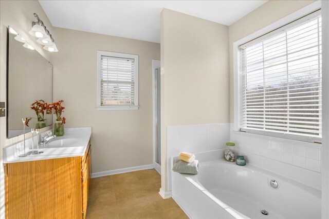 bathroom featuring shower with separate bathtub, vanity, and tile patterned flooring