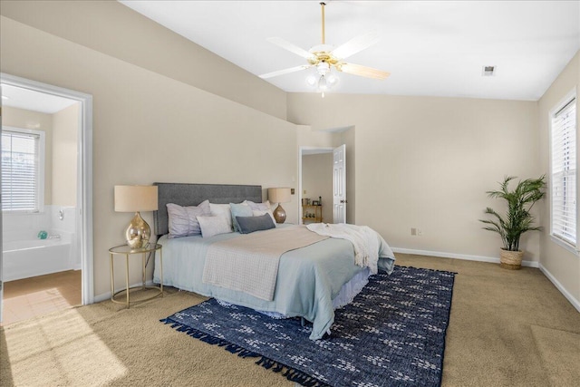 carpeted bedroom with ceiling fan and ensuite bathroom