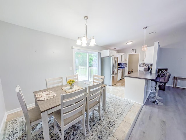 5 Drummond Ct, Charleston, SC 29414 - dining space with a chandelier, lofted ceiling, light tile patterned flooring, and baseboards