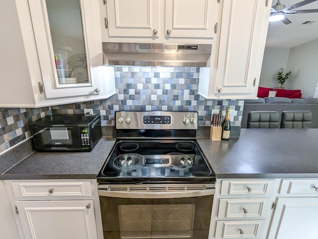 5 Drummond Ct, Charleston, SC 29414 - kitchen with stainless steel range with electric stovetop, under cabinet range hood, white cabinetry, dark countertops, and black microwave