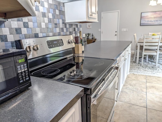 5 Drummond Ct, Charleston, SC 29414 - kitchen featuring stainless steel electric range oven, dark countertops, tasteful backsplash, and white cabinetry
