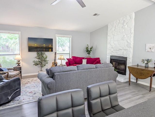 5 Drummond Ct, Charleston, SC 29414 - living room featuring healthy amount of natural light, a ceiling fan, a stone fireplace, and wood finished floors