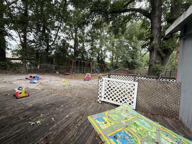 715 Yew St, Charleston, SC 29407 - wooden deck featuring a playground, a fenced backyard, and view of scattered trees