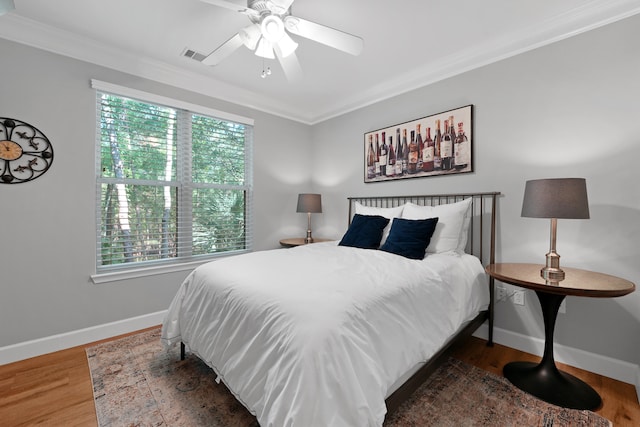 bedroom featuring ornamental molding, ceiling fan, and dark wood-type flooring