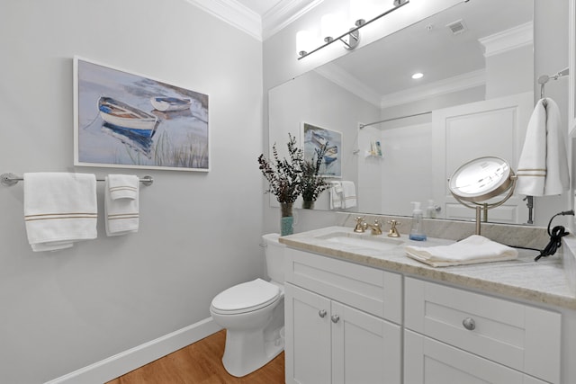 bathroom with vanity, hardwood / wood-style flooring, walk in shower, crown molding, and toilet