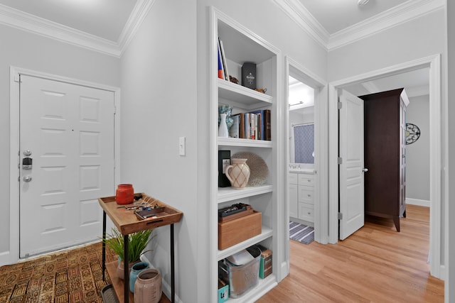 hallway with crown molding and light hardwood / wood-style floors