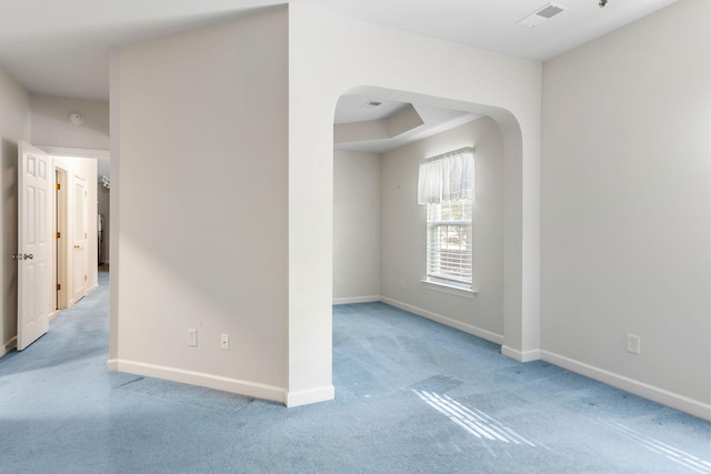 spare room featuring light colored carpet