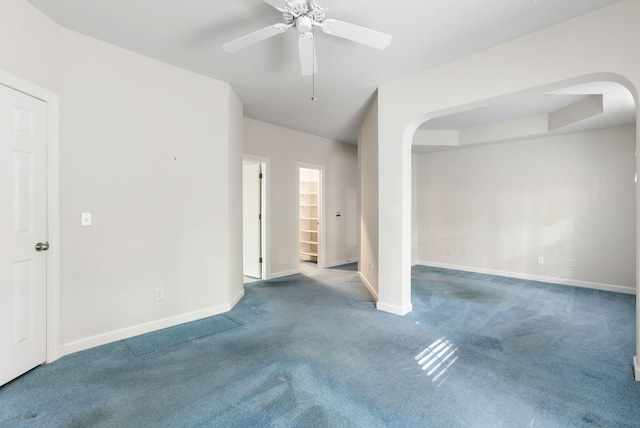 carpeted spare room featuring ceiling fan