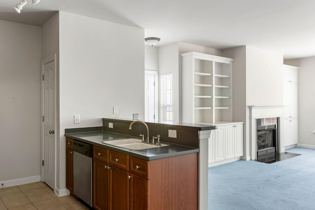 kitchen featuring kitchen peninsula, dishwasher, sink, and light carpet