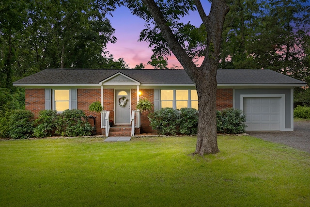 7239 Commodore Rd, Hollywood, SC 29449 - ranch-style house featuring an attached garage, a front lawn, driveway, and brick siding