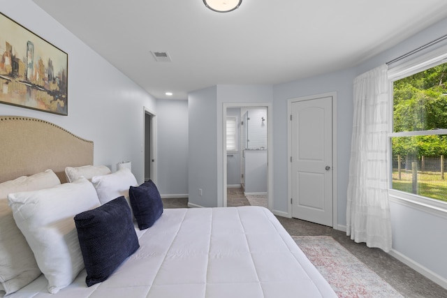 7239 Commodore Rd, Hollywood, SC 29449 - carpeted bedroom with multiple windows, baseboards, and connected bathroom