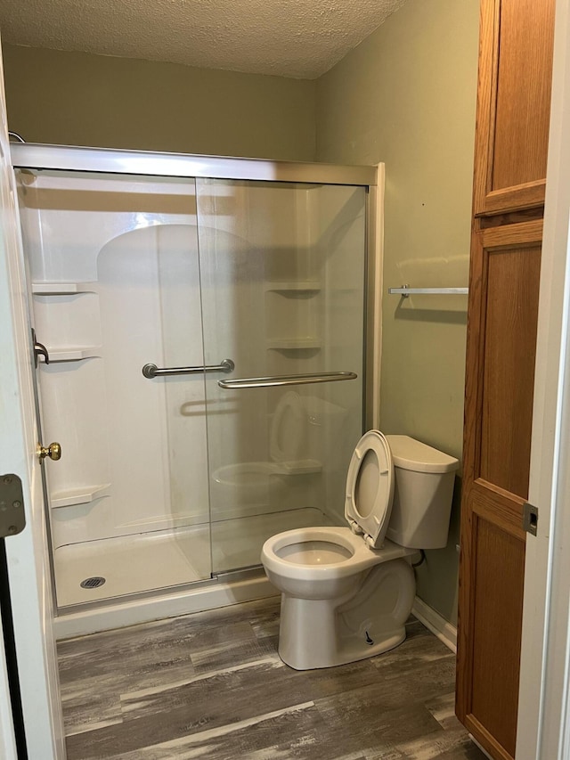214 Hardee Ave, Summerville, SC 29485 - full bath with a stall shower, toilet, wood finished floors, a textured ceiling, and baseboards