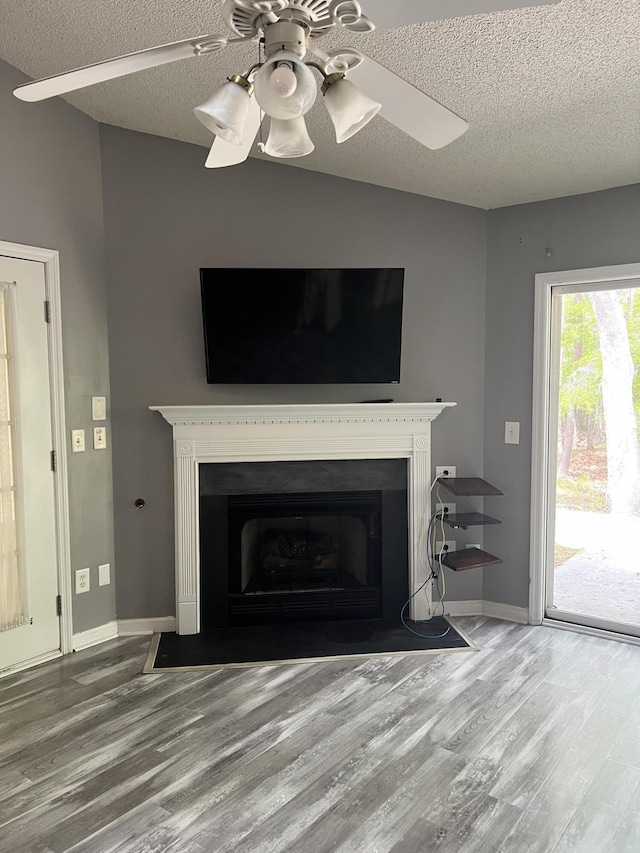 214 Hardee Ave, Summerville, SC 29485 - interior space with a fireplace with flush hearth, a textured ceiling, wood finished floors, and a ceiling fan