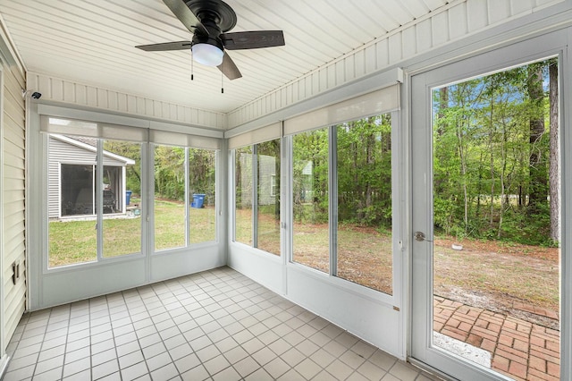 unfurnished sunroom featuring ceiling fan