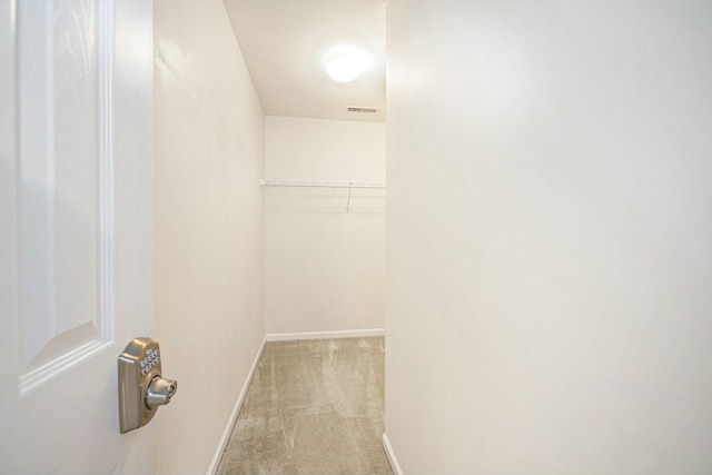 walk in closet with visible vents and carpet
