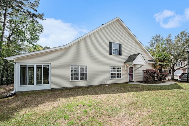 rear view of house featuring a yard