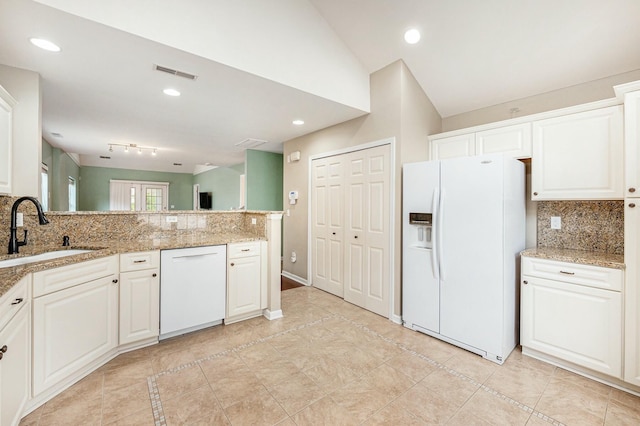 kitchen featuring vaulted ceiling, white appliances, white cabinets, visible vents, and a sink
