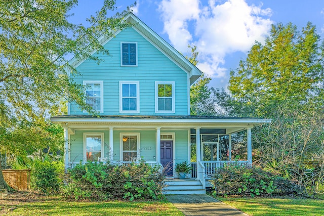 view of front of home with a porch and a front yard