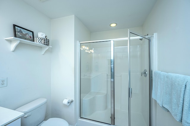 bathroom featuring vanity, toilet, and walk in shower