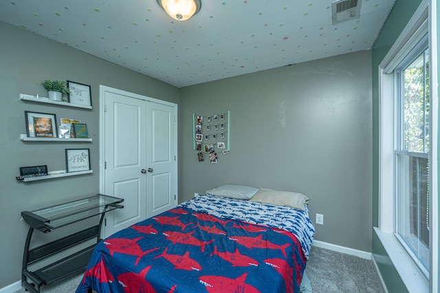 bedroom featuring carpet and a closet