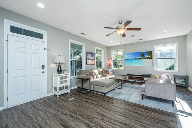 living room featuring dark hardwood / wood-style flooring and ceiling fan