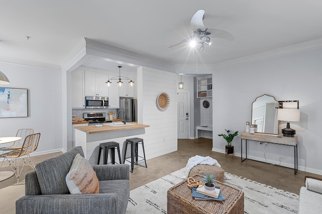 living room featuring ceiling fan and ornamental molding