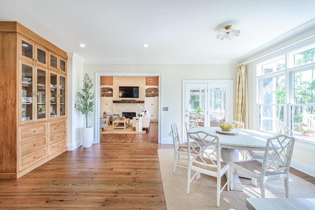 3130 Pignatelli Cres, Mount Pleasant, SC 29466 - dining space featuring plenty of natural light, ornamental molding, a fireplace, wood finished floors, and baseboards