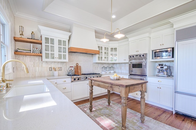 3130 Pignatelli Cres, Mount Pleasant, SC 29466 - kitchen featuring a sink, built in appliances, custom range hood, white cabinetry, and ornamental molding