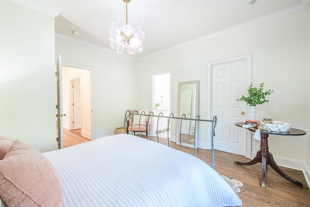 3130 Pignatelli Cres, Mount Pleasant, SC 29466 - bedroom with crown molding, wood finished floors, baseboards, and a chandelier