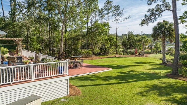 3130 Pignatelli Cres, Mount Pleasant, SC 29466 - view of green lawn featuring a wooden deck, outdoor dining area, and view of wooded area