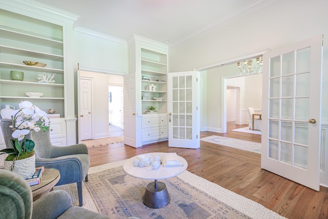 3130 Pignatelli Cres, Mount Pleasant, SC 29466 - living area with french doors, a chandelier, crown molding, built in shelves, and wood finished floors