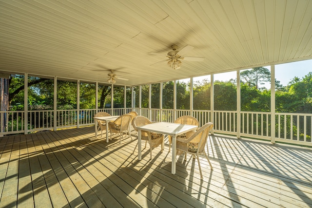 unfurnished sunroom with ceiling fan