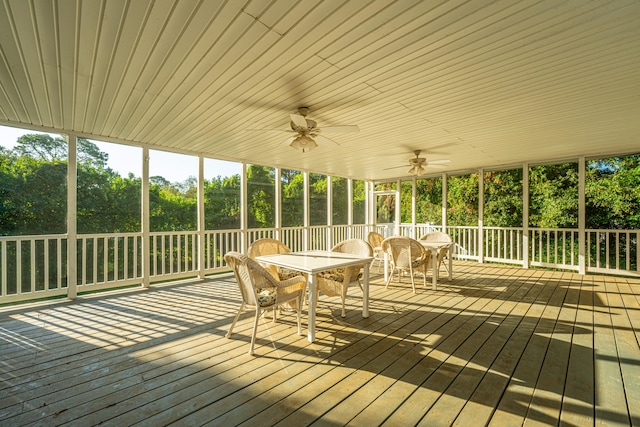 unfurnished sunroom with ceiling fan