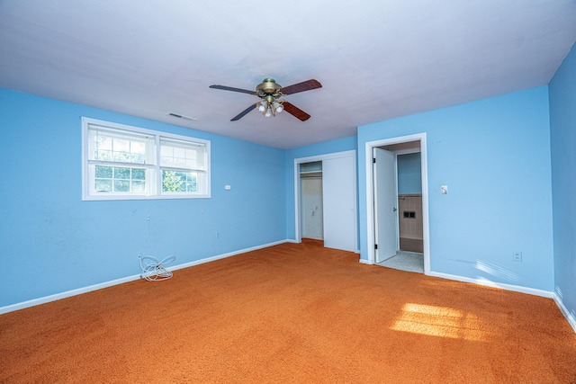 unfurnished bedroom with a closet, carpet floors, and ceiling fan