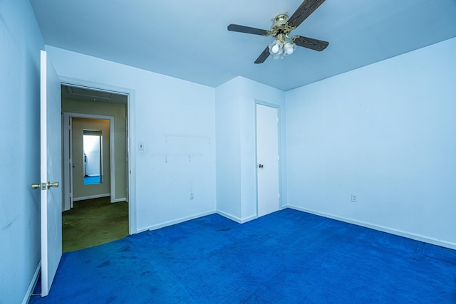 unfurnished bedroom featuring ceiling fan and dark carpet